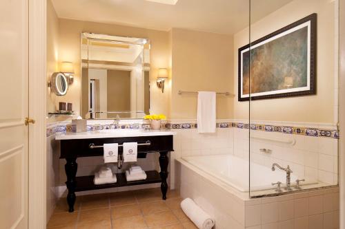 a bathroom with a tub and a sink and a bath tub at Green Valley Ranch Resort Spa Casino in Las Vegas