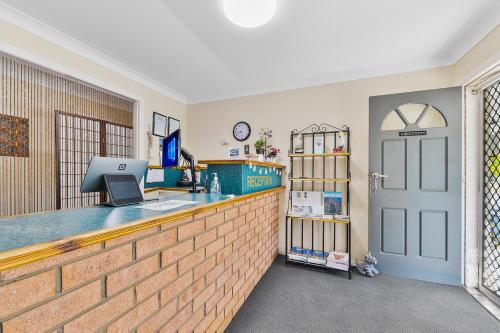 a kitchen with a brick counter and a door at Castlereagh Motor Inn in Gilgandra