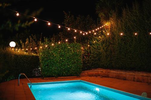 a swimming pool in a yard with lights at Quinta da Quintã AL in São Pedro do Sul