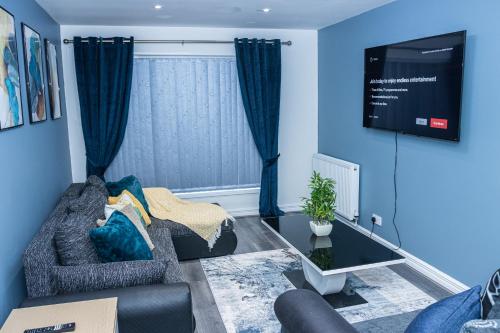 a living room with a couch and a tv at Lush Lodge -Home away in Telford, For Contractors, families, group of friends, Long Term Stays in Telford