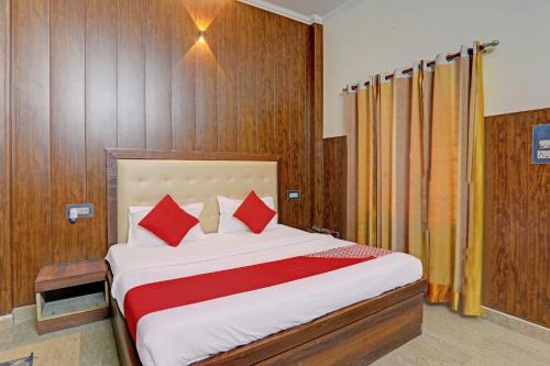 a bedroom with a large bed with red pillows at OYO Flagship Hotel CZ Inn in Lucknow