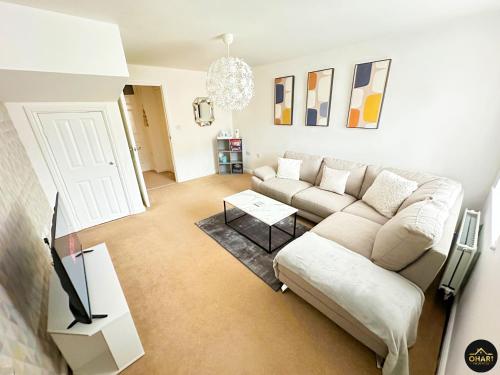 a living room with a couch and a table at Modern 3 Bedroom House With FREE Parking in Kenton