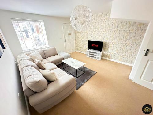 a living room with a couch and a tv at Modern 4 Beds House With FREE Parking in Kenton