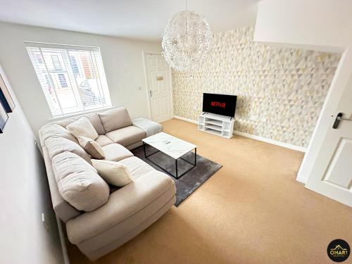 a living room with a couch and a tv at Modern 3 Bedroom House With FREE Parking in Kenton