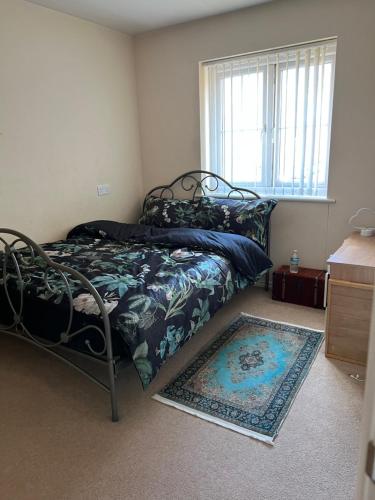 a bedroom with a bed and a window and a rug at Maidstone, Birmingham, Uk in Birmingham