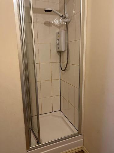 a shower in a bathroom with a glass door at Maidstone, Birmingham, Uk in Birmingham
