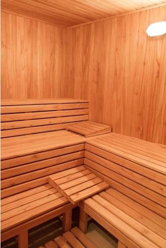 a wooden sauna with two wooden benches in it at Monoambiente Frente Al Hospital Italiano in Buenos Aires