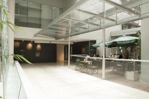 a restaurant with people sitting at tables in a building at Monoambiente Frente Al Hospital Italiano in Buenos Aires