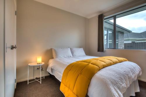 a bedroom with a bed with a yellow blanket on it at Cambridge Sunshine 5 Bedrooms House in Cambridge