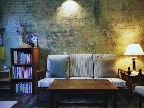 a living room with a couch and a table at LEJU 21 樂居 Explore Malacca from a riverside house in Melaka