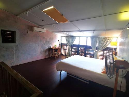 a bedroom with a bed and a table and chairs at LEJU 21 樂居 Explore Malacca from a riverside house in Melaka