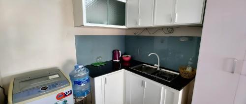 a small kitchen with a sink and a dishwasher at SKY HOMESTAY in Buon Ma Thuot