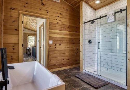 a bathroom with a tub and a shower at Smoky Lake Retreat cabin in Dandridge