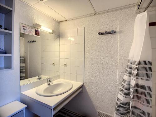 une salle de bain avec un lavabo et une douche dans l'établissement Charmant T2 avec Wi-Fi, ascenseur, proche Thermes et centre-ville, idéal pour curistes, animaux acceptés - FR-1-451-178, à Lamalou-les-Bains