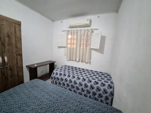 a bedroom with a bed and a air conditioner at Casa 01 simples e aconchegante em Maragogi in Maragogi