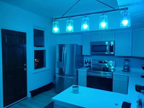 a kitchen with blue lighting in a kitchen at Newly renovated -2 Bedroom Condo in Boston