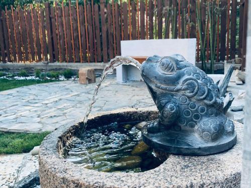 a bird bath with a water fountain at Gorgeous apartment with private backyard in Wuhan