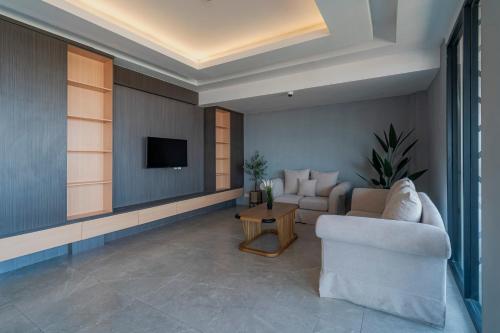 a living room with a couch and a tv at Stay.vie Hotel in Surabaya