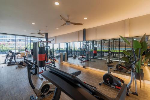a gym with treadmills and exercise equipment in a building at Stay.vie Hotel in Surabaya