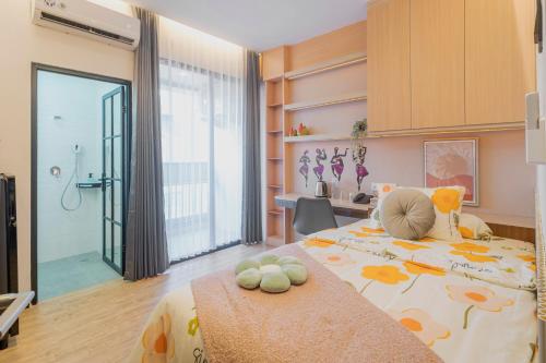 a bedroom with a large bed with flowers on it at Stay.vie Hotel in Surabaya