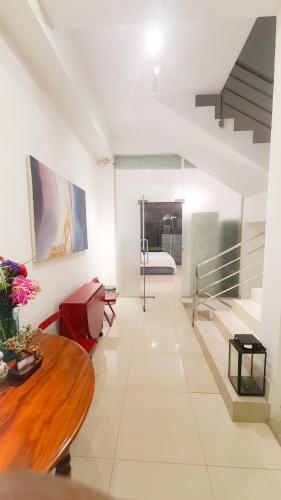 a room with a table and a bed in the background at Lotus Colombo Guesthouse in Colombo