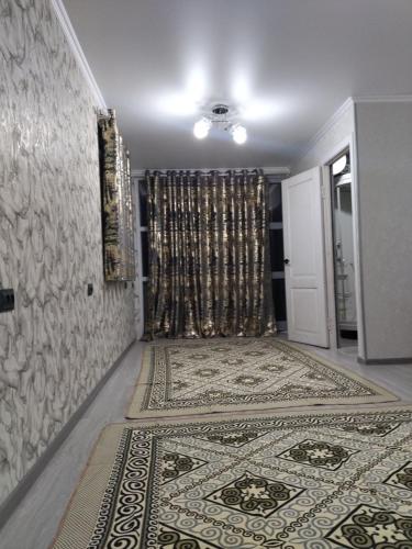 a hallway with a room with a carpet and a door at D&N Karakol in Karakol