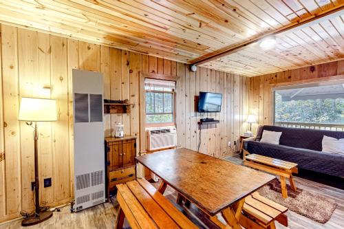 a living room with a table and a couch at Dragonfly Gully in Rhinelander