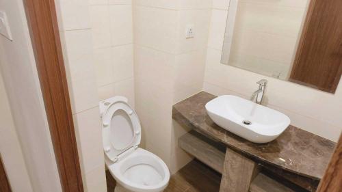 a bathroom with a white toilet and a sink at SleepRest @ NTC in Nagoya