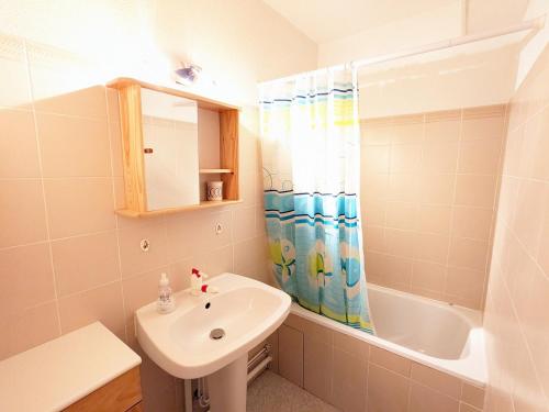 a bathroom with a sink and a shower curtain at Appartement La Clusaz, 2 pièces, 6 personnes - FR-1-459-219 in La Clusaz