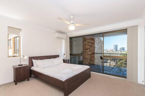 a bedroom with a bed and a large window at The Hidden Flower - A Spacious Poolside Abode in Brisbane