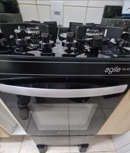a black stove top sitting on top of a counter at Apartamento Beira mar Capão da Canoa in Capão da Canoa