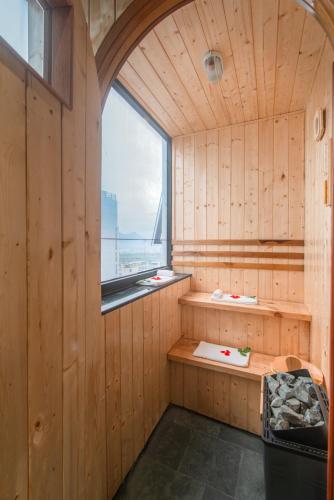 a sauna with a window in a wooden wall at Maple Hotel & Apartment in Nha Trang