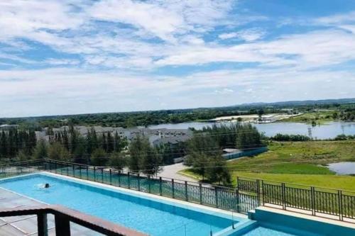a view of a swimming pool with a view of a lake at Champs Elysees Homestay by Landmark @ Kampar in Kampar