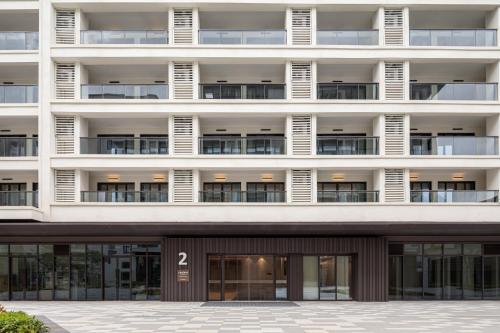 an apartment building with the number on it at Citadines Hope City Boao in Qionghai