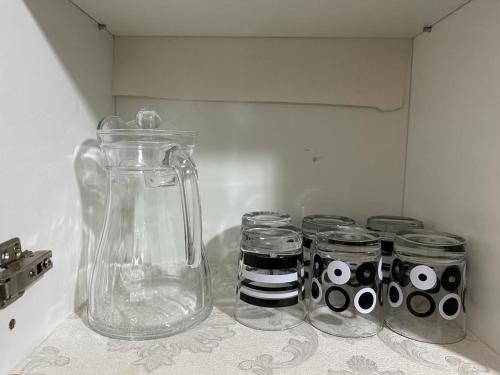 a kitchen counter with jars and a glass jug at Kyra The Heights Residence Condo Ayer Keroh Melaka WiFi, Netflix & Pool in Ayer Keroh