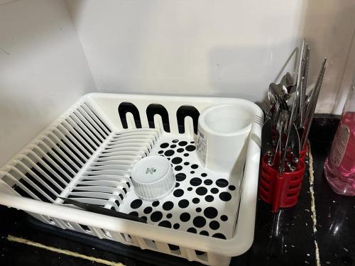 a white dish drying rack with utensils in it at Kyra The Heights Residence Condo Ayer Keroh Melaka WiFi, Netflix & Pool in Ayer Keroh