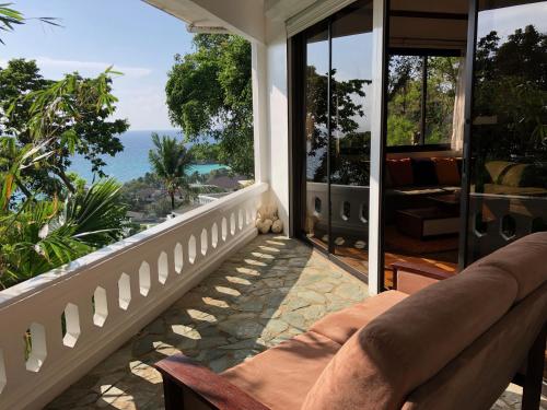 a porch with a couch and a view of the ocean at Argonauta Boracay Apartment Suites and Villas in Boracay