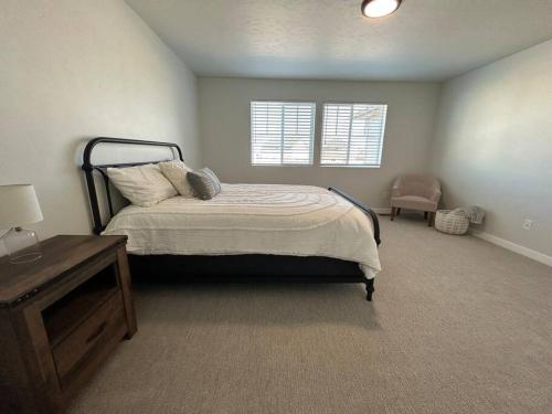 a bedroom with a bed and a table and a window at Countryside Classic in Nampa