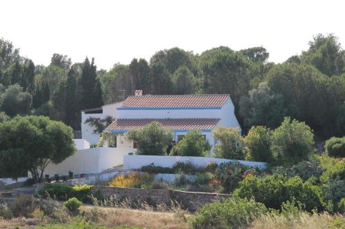 a white house with a garden in front of it at Villa Pein in Carloforte