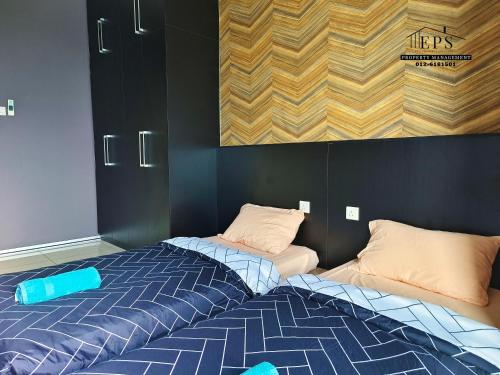 a bedroom with a bed and two pillows at DaMen Homestay @SubangHomeStay in Subang Jaya