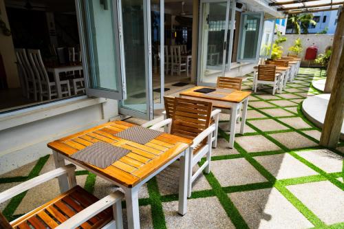 a row of tables and chairs on a patio at Aquarius On The Beach in Nadi