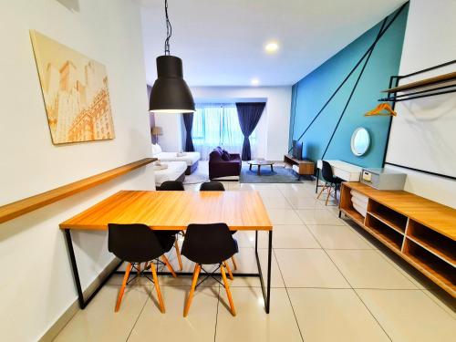 a living room with a wooden table and chairs at DaMen Homestay @SubangHomeStay in Subang Jaya