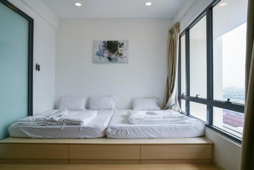 a bed in a room with a large window at USJ One HomeStay @ Subang HomeStay in Subang Jaya