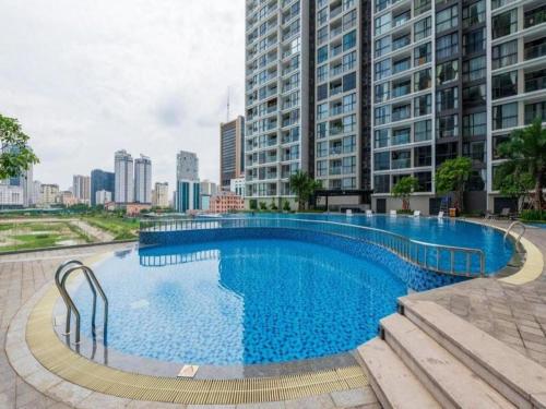a large swimming pool in a city with tall buildings at Vincom Plaza Vinhomes Sky Lake Phạm Hùng Mỹ Đình in Hanoi