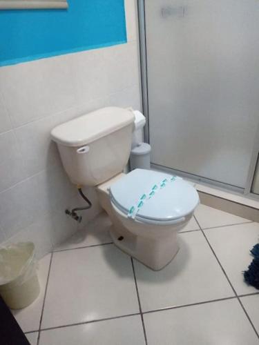 a bathroom with a white toilet in a room at Colinas C12-2 in San Carlos