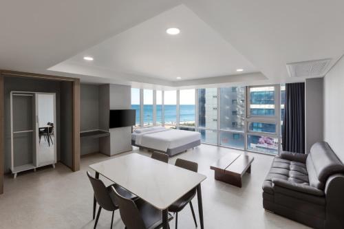 a living room with a couch and a table at Sun Cloud Hotel in Busan