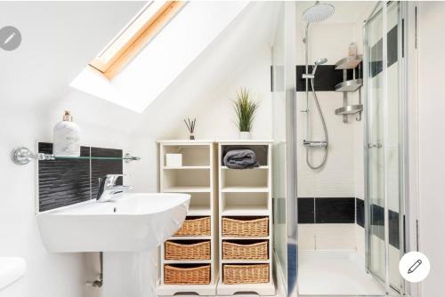 a bathroom with a sink and a shower at Dartford Terrace Lakefront in Kent