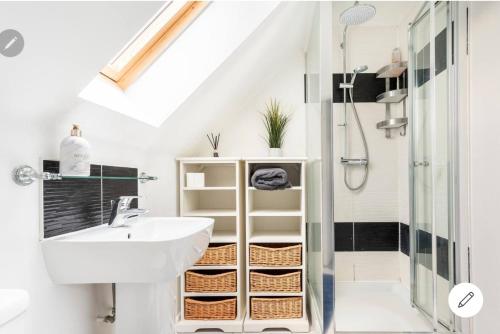 a bathroom with a sink and a shower at Dartford LakeView Terrace in Kent