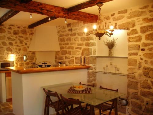 a kitchen with a table and chairs in a room at Hvar Architect's House in Pitve