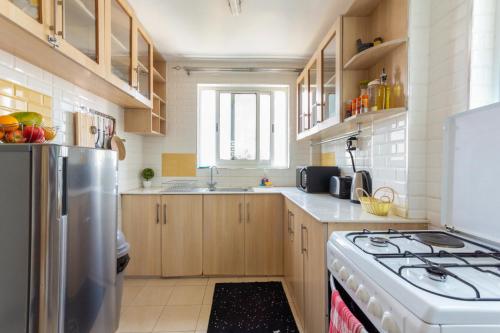 a kitchen with a stove and a refrigerator at Neema Suites, Ngong RD near Junction in Nairobi